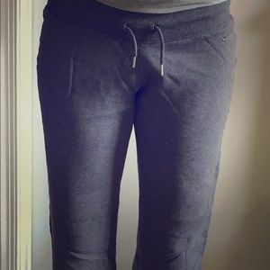 Grey workout pants that are loose fitting.